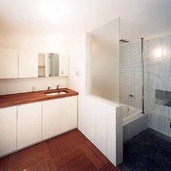 白いタイルで浴室を包み込んだ、清潔感ある広い浴室