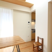 白い壁にトップライトの光が反射する明るい空間