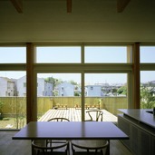 リビング・ダイニングと同じ床高さにウッドデッキ。ティータイムを楽しむ