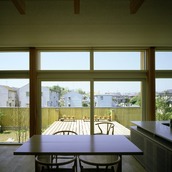 リビング・ダイニングと同じ床高さにウッドデッキ。ティータイムを楽しむ