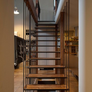 スチール枠に濃い木目の踏み板でヴィンテージ感のある階段