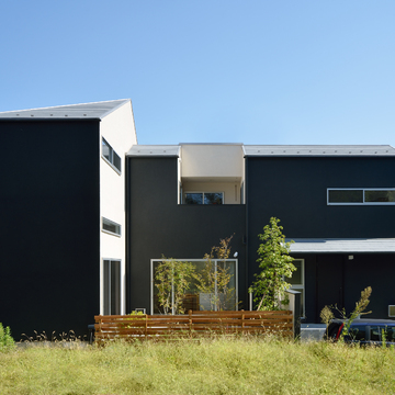 白い物体を黒で包み込んだような配色のモダンな家