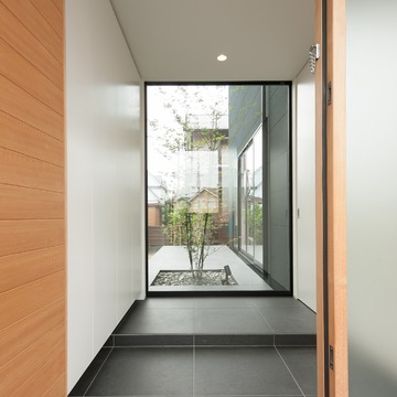 正面窓から見えるシンボルツリーが映える和モダンな玄関