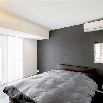 黒い壁がアクセントの寝室