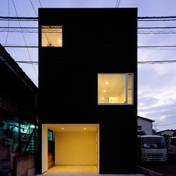 夜の光が黒い外壁を柔らかな印象に変える外観