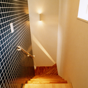 黒タイル壁・ステンレス手すりで、男前な空間に作り上げられた階段