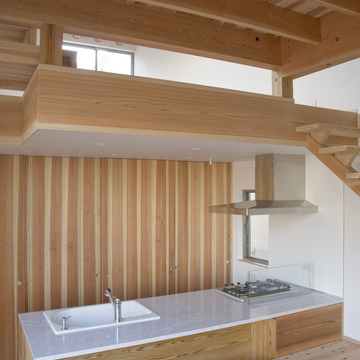 背面収納と御影石を使った対面式キッチンカウンター