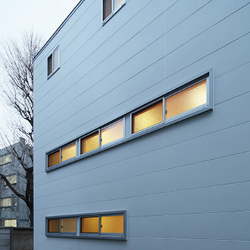 長窓からの灯りが白い外観に彩りを添える