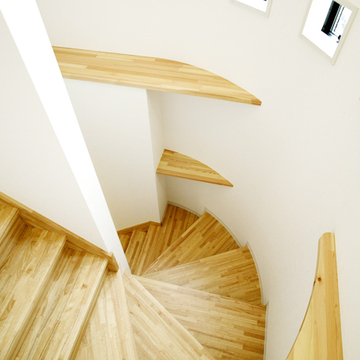 R状の形を活かして収納棚を付けた階段