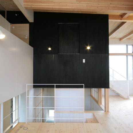 白とナチュラルな木目の空間に存在感のある黒い壁面