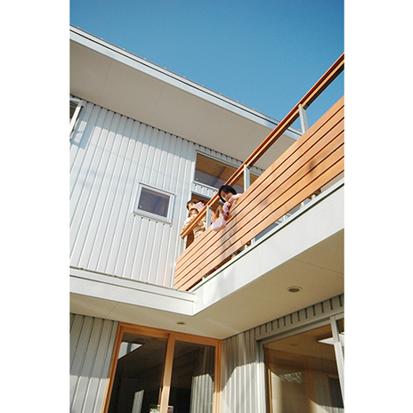 1階の庭を覗くバルコニーがある家