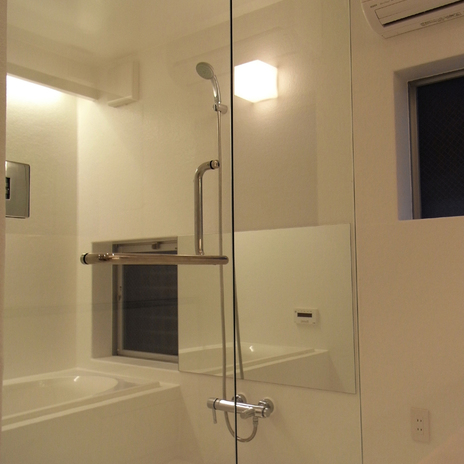 浴室扉と仕切りをガラスにし、洗面ルームと一体化して見えるバスルーム