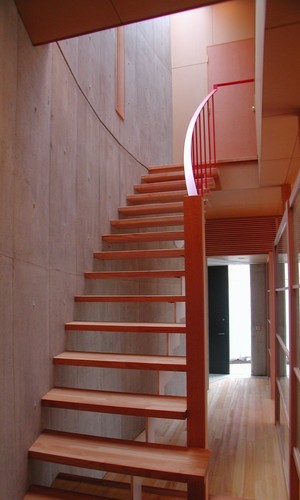 明るい光が差し込む暖かい色調の階段ホール