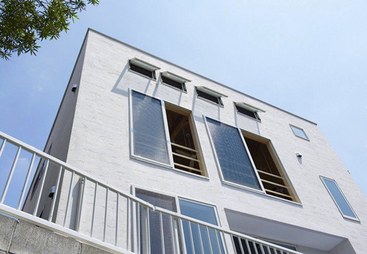 小窓が並ぶ白壁のファサード