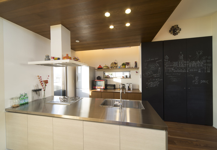 すっきりとまとめたオシャレなカフェのような、黒板のある収納壁をもつキッチン