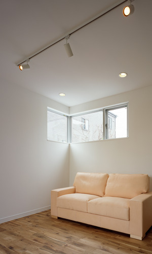 Ｌ字に窓を設け、真っ白の壁・天井にポイントとなる景色が見えるリビング