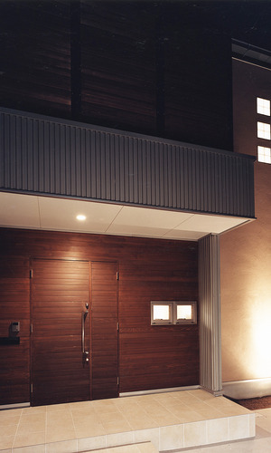 玄関ドア周りの外壁と玄関ドアを同じ木材にした、迫力ある玄関アプローチ