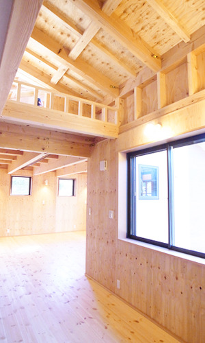 吹き抜けと大きな窓で明るく照らす廊下