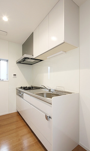 コンパクトで機能的な白いシステムキッチン