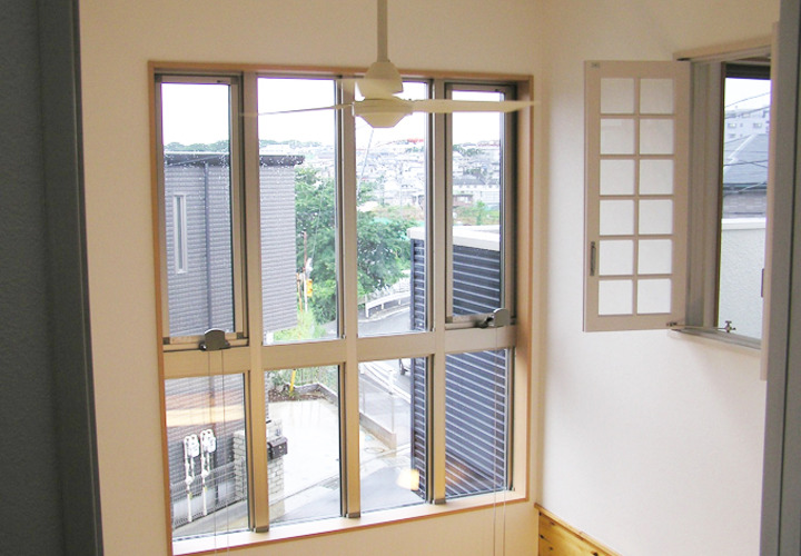 大きな窓から自然光が降り注ぐ洋間の吹抜け