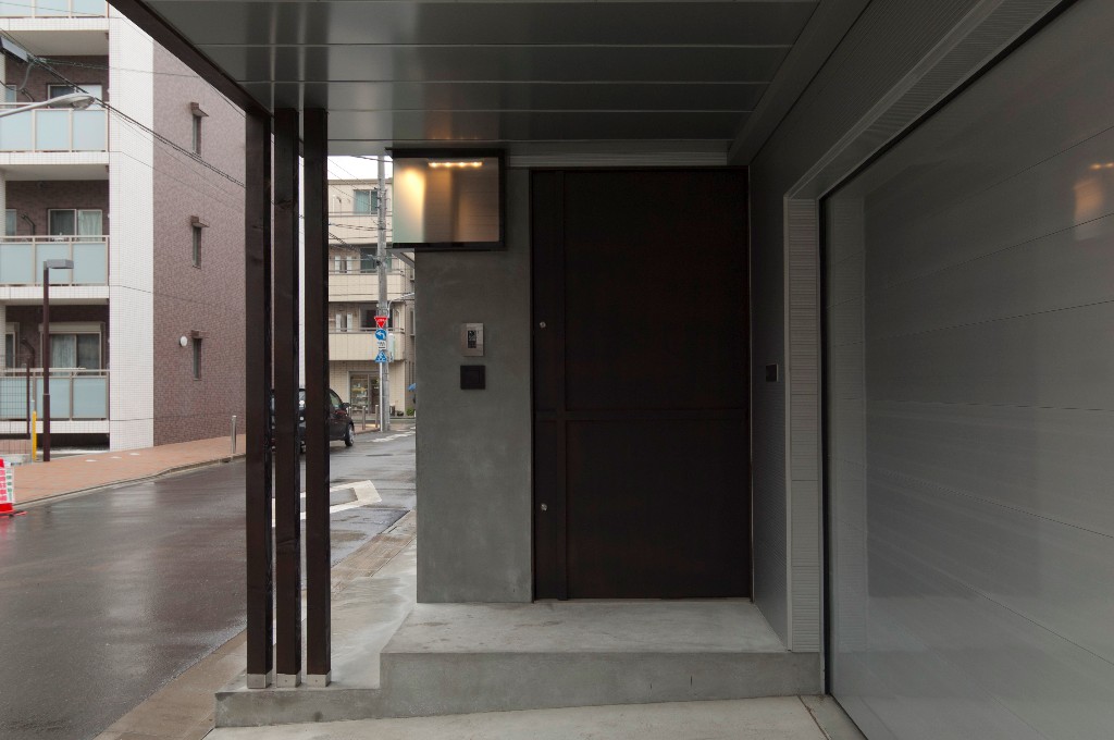 モルタルとスチールの組み合わせのエントランスで味のある質感