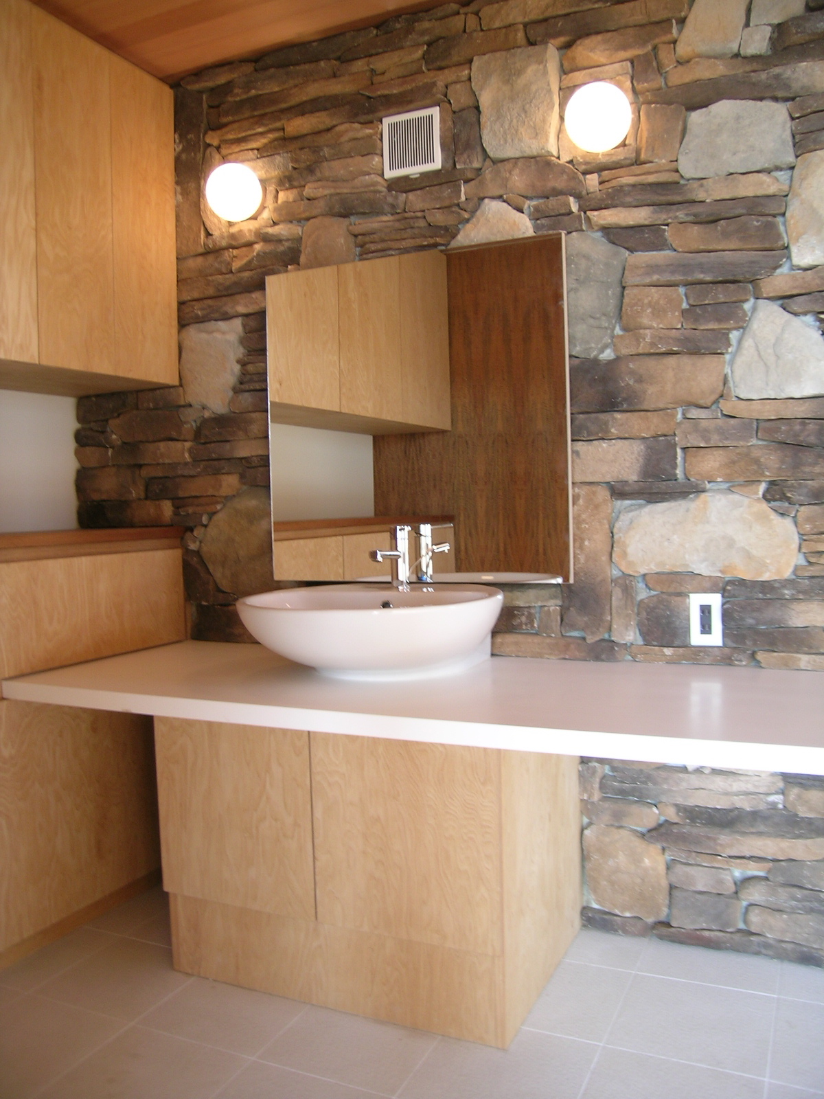 木と石の自然の風合いが高級感を演出する洗面スペース