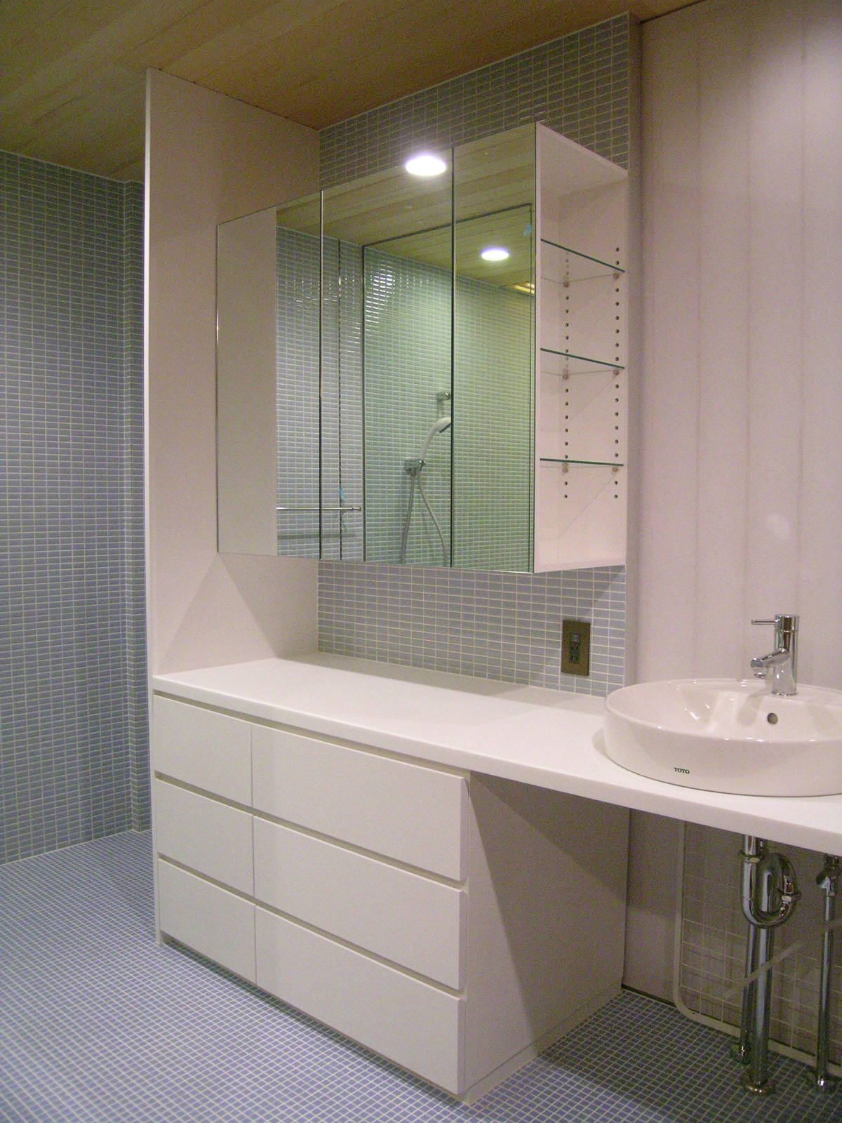 青いタイルと白い建具が爽やかな洗面スペース