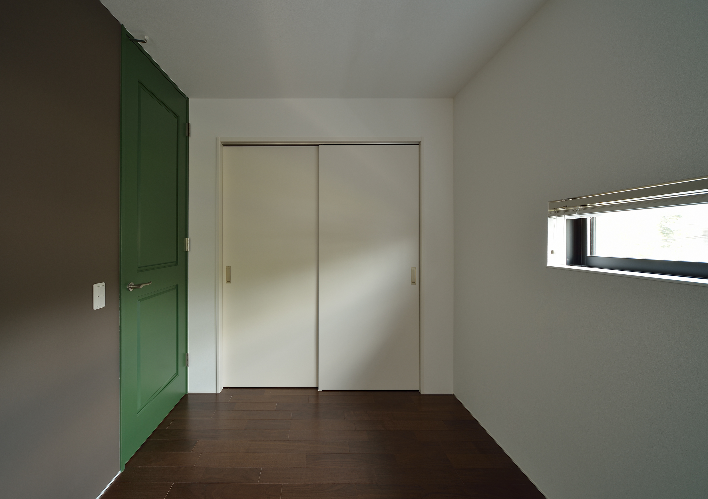 グリーンの扉と相性のよいグレーの壁