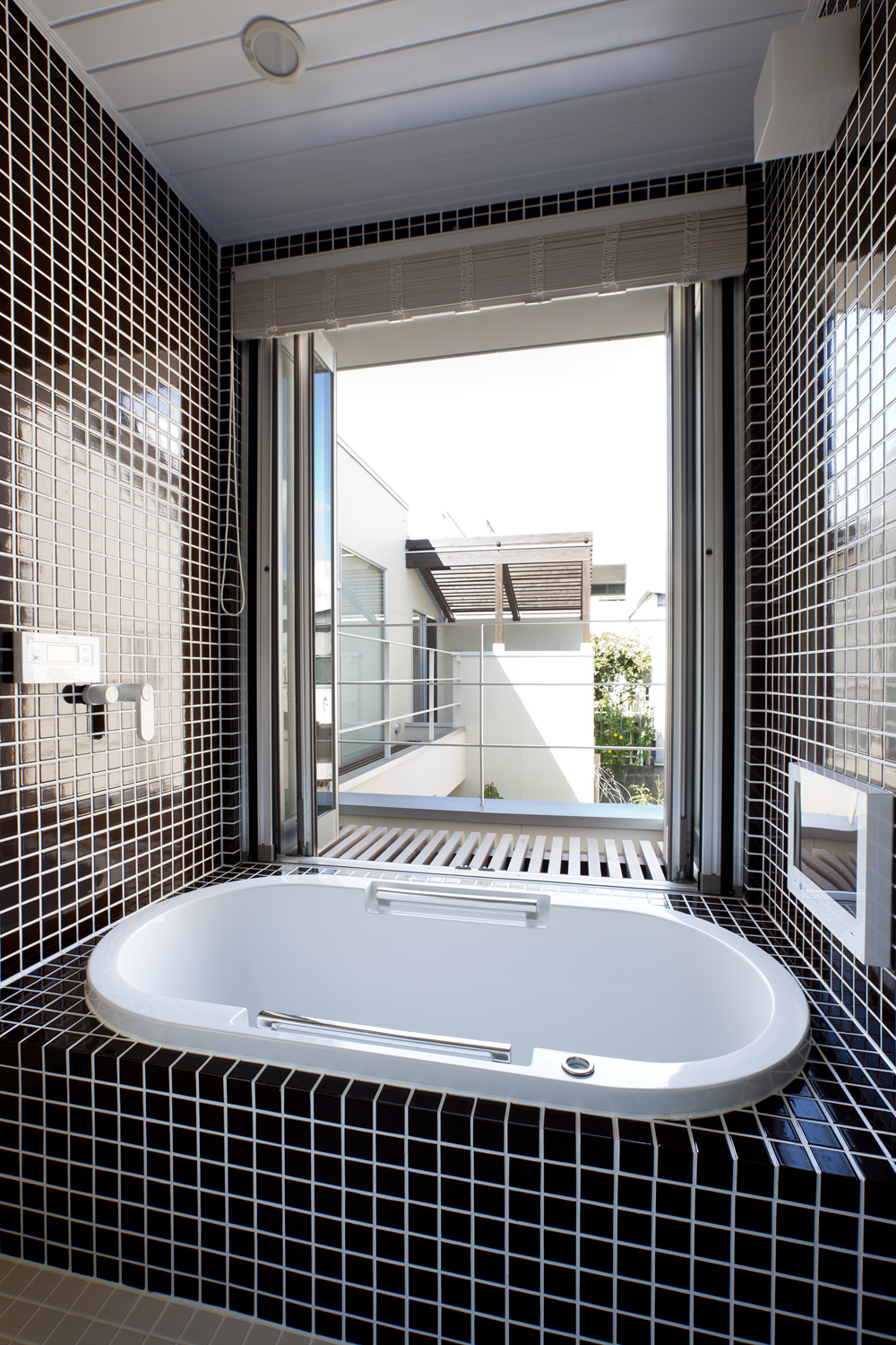 折れ戸を開けると光も風も充分に入ってくる開放的な浴室