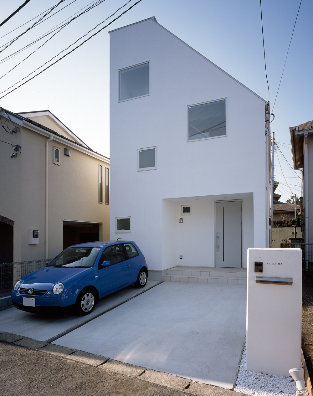 スクエアな窓をランダムに配置してリズムを与えた、真っ白でシンプルな外観